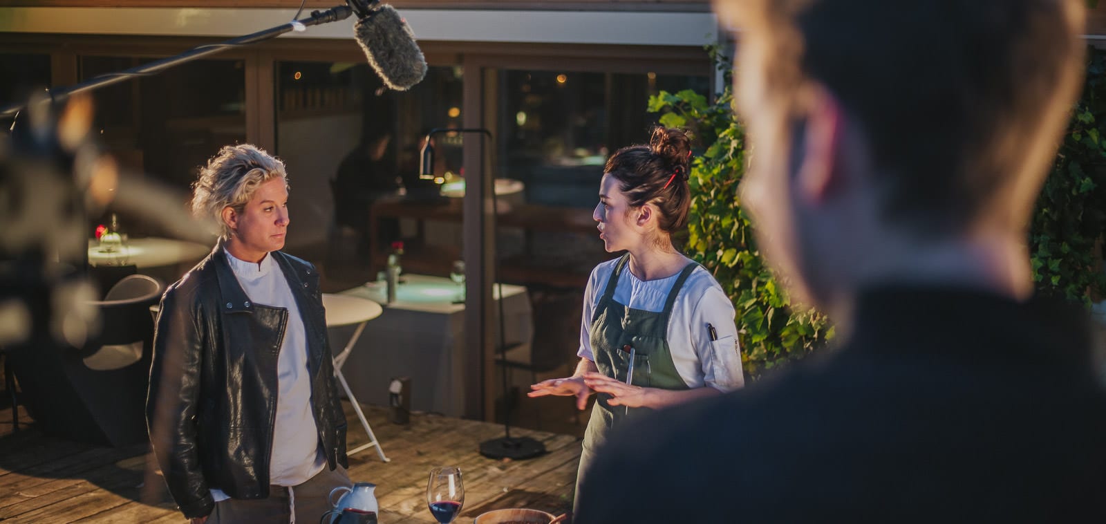 Squareme Mastercard Sous Chef campaign for Michelin star winners in Slovenia - Award winning chef Ana Roš and her assistant are talking about food on her garden patio while a film crew is filming them